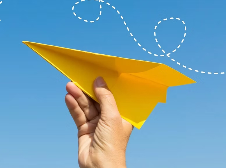 hand holding paper plane line white dotted lines